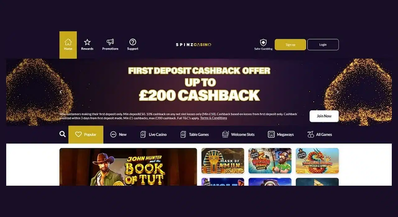 Clean historical Spinz Casino homepage with the full logo, navigation, signup and login buttons, cashback banner and game menu visible